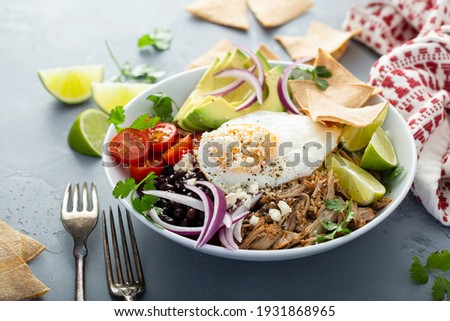 Breakfast burrito bowl with pork carnitas, tomato, beans and rice Royalty-Free Stock Photo #1931868965