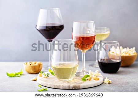 Red, white wine and rose in different glasses, variety of wine Royalty-Free Stock Photo #1931869640
