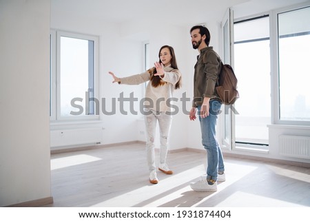 Young couple moving and planning in new flat, new home and relocation concept. Royalty-Free Stock Photo #1931874404
