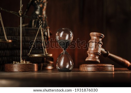 Judge gavel, scales and hourglass. Law and time concept Royalty-Free Stock Photo #1931876030