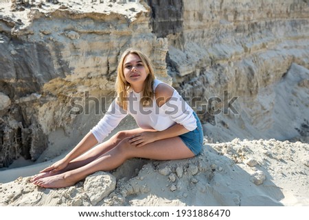 beautiful young woman in sand quarry, summer time. adventure