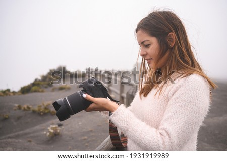 stock photos of portraits of beautiful female latin photographer walking and photographing the top of a mountain