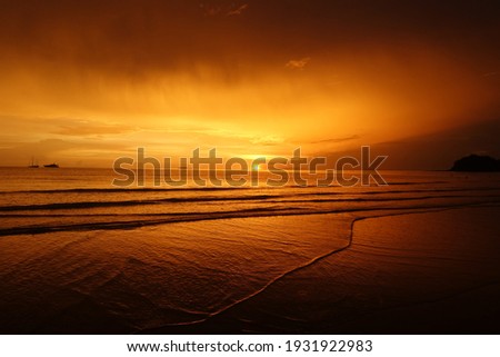 Last gasp of the sun as it sets on Klong Dao beach in Koh Lanta, Thailand