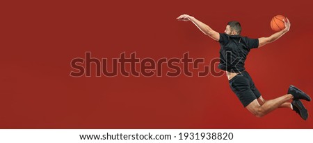 Website header of Handsome Caucasian bearded basketball player playing in basketball in sport center