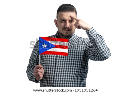 White guy holding a flag of Puerto Rico and a finger touches the temple on the head isolated on a white background.