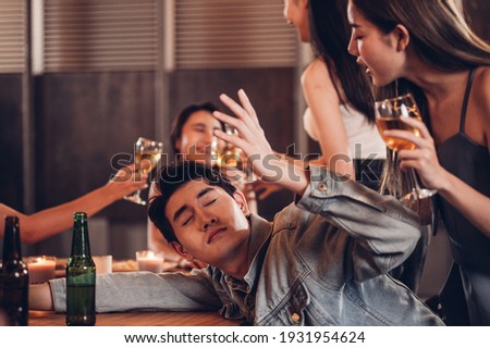 Drunk young man sleeps on the dining table.