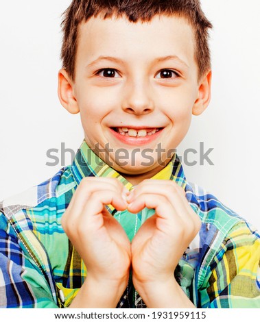 little cute boy on white background gesture tumbs up smiling closeup, lifestyle happy real people concept