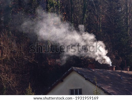 Smoke coming out of the chimney of a house in northern Croatia