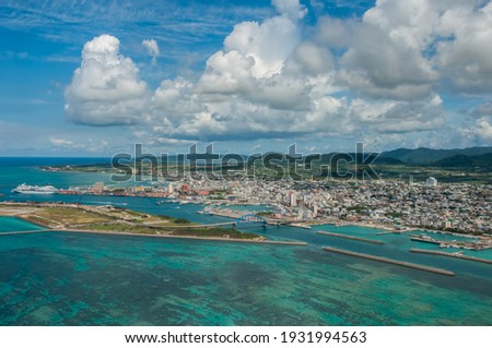 Top view of Ishigaki Island city and foreground the breathtaking coral reefs seen from the plane.  Royalty-Free Stock Photo #1931994563