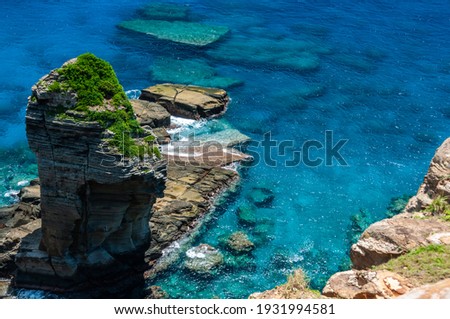 Closeup of famous Tategami Rock surrounded by coral reefs and an impressive crystalline turquoise sea. Yonaguni Island. Royalty-Free Stock Photo #1931994581