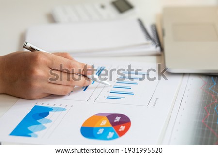 Close up of accountant working and analyzing financial reports project accounting with chart graph and calculator in modern office : finance and business concept. Royalty-Free Stock Photo #1931995520