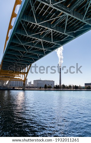 A smokestack on jones island emits water vapor into the blue sky in Milwaukee, Wisconsin
