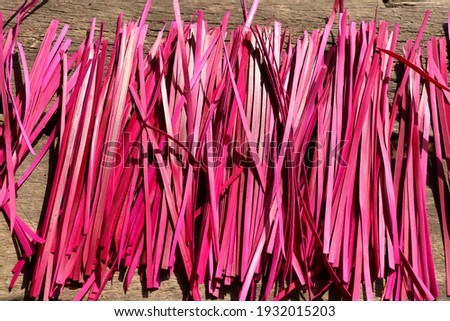 Colored reed stalks for Hindu offerings and ceremonies. Pink colored grass atte