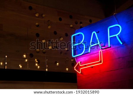 Neon gas bar sign or gas advertising on wall background in blue and red color