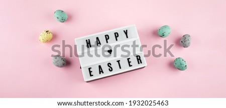 Easter spring holiday greeting card. Lightbox with text Happy Easter. colorful easter eggs, rabbits. Flat lay, top view. Banner