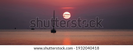 Silhouette image of a beautiful sunset  at the sea with sail boat