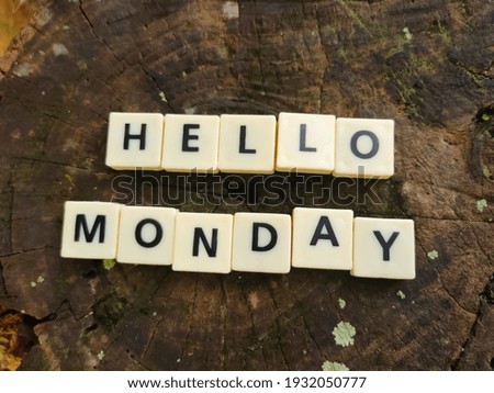 Selective focus.Blur scrabble letters with text HELLO MONDAY on blur wooden background.