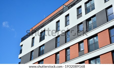 Cityscape with facade of a modern residential building. Modern European residential apartment building. Royalty-Free Stock Photo #1932089168