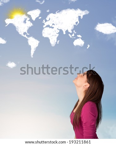 Young casual girl looking at world clouds and sun on blue sky