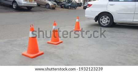 The rubber cone on the road is a sign to be careful.
Parking cone.