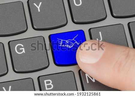 Computer keyboard with handshake button - technology background