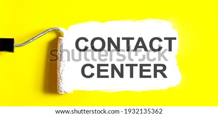 CONTACT CENTER . One open can of paint with white brush on it on yellow background.