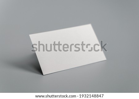 Blank business card on gray background
