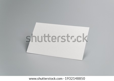 Blank business card on gray background