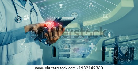 Medicine doctor touching on tablet and digital healthcare and network connection with modern virtual screen interface icons on the hospital background, Medical technology and network concept.