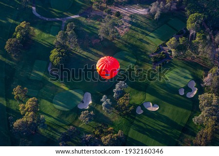 Hot air balloon flying over a golf course in Australia 