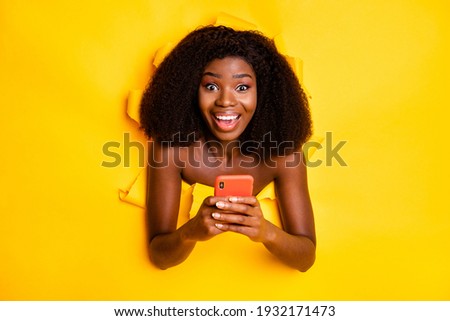 Photo of charming lady hold telephone open mouth look camera isolated ripped yellow color background
