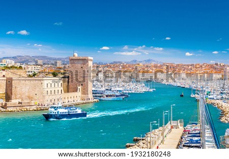 Aerial panoramic view of Marseille Old Port with yachts and boats and the city, mountains in the background. Marseille, Provence, France. Holidays in France Royalty-Free Stock Photo #1932180248
