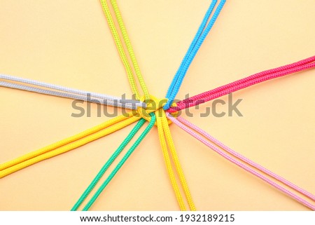 Tied ropes on color background. Unity concept Royalty-Free Stock Photo #1932189215