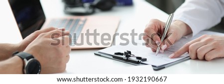 Doctors hands writing down patients complaints in medical history closeup. Medical consultation concept Royalty-Free Stock Photo #1932190667