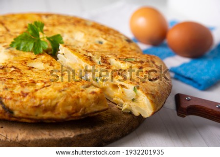 Traditional Spanish omelette with potatoes and zuuchini Royalty-Free Stock Photo #1932201935