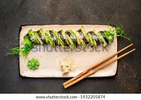 Sushi roll  - green dragon on a stone background