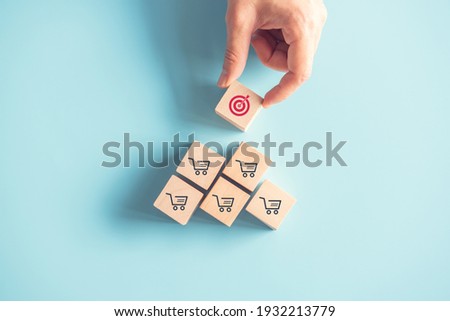 Sale volume increase make business goal success, Wood cube with icon goal and shopping cart symbol. Royalty-Free Stock Photo #1932213779