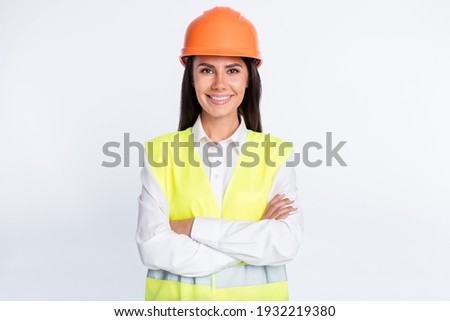 Photo of confident cheerful lady beaming smile look camera wear helmet shirt vest isolated white color background