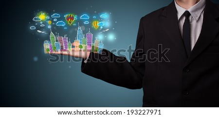 Young business man in suit presenting colorful hand drawn metropolitan city