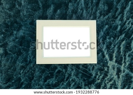 Poster product design, styled stock harsh conditions. Home decor thing. Photo frame on background of an icy surface
