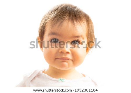 Close-up of a 1 year old baby girl with a Surprised face expression