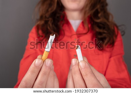 broken cigarette in hand, stop smoking .