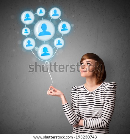 Young woman holding social network balloon