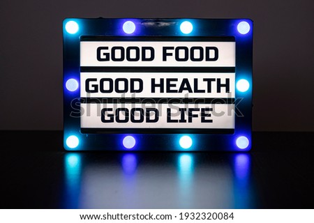Lightbox with blue lights in dark with words - good food, good health, good life.