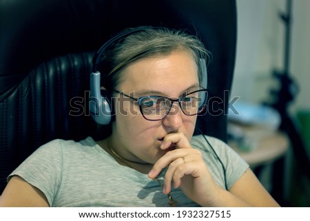 Young woman freelancer with glasses working at home using a laptop