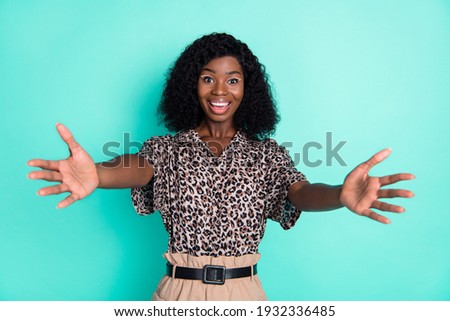 Photo of lovely friendly lady stretch hands look camera wear leopard print shirt isolated teal color background