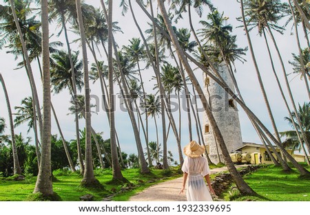 Girl in Sri Lanka on an island with a lighthouse. Selective focus. nature. Royalty-Free Stock Photo #1932339695