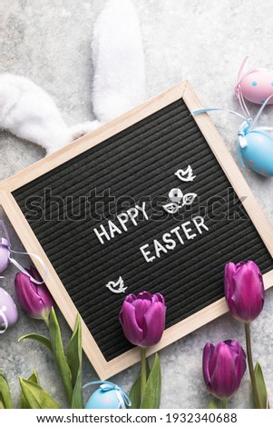 Beautiful purple  tulips on light background flat lay. Spring concept and Happy Easter greeting card, gift, poster, web concept.