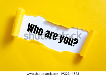 Who are you? question written under torn paper.	 Royalty-Free Stock Photo #1932344393