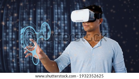 Digital interface with data processing over man using vr headset against blue background. futuristic technology and business concept